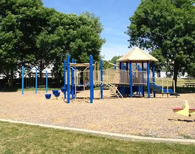 a playground with blue poles and a play structure
