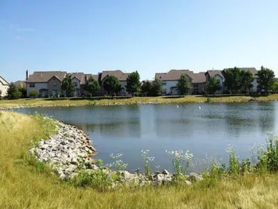 a lake with houses in the background