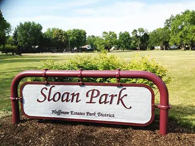 a sign in front of a park
