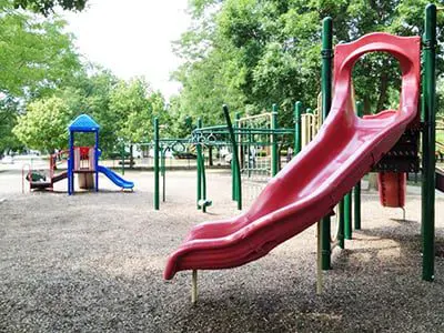 a red slide on a playground