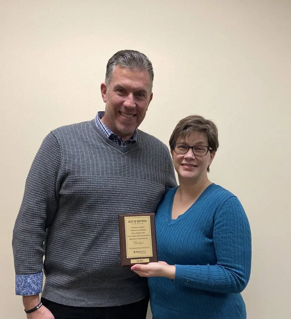 a person and person holding a plaque