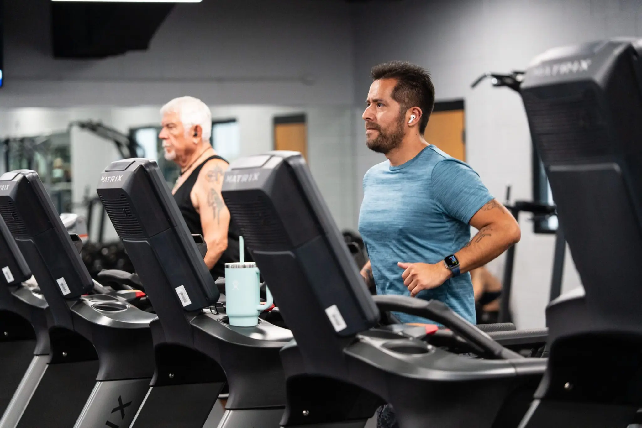 a person running on treadmills in a gym