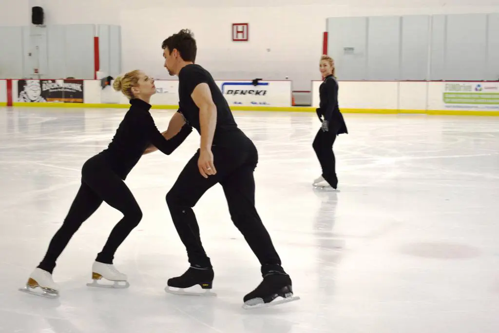 a group of people skating on ice
