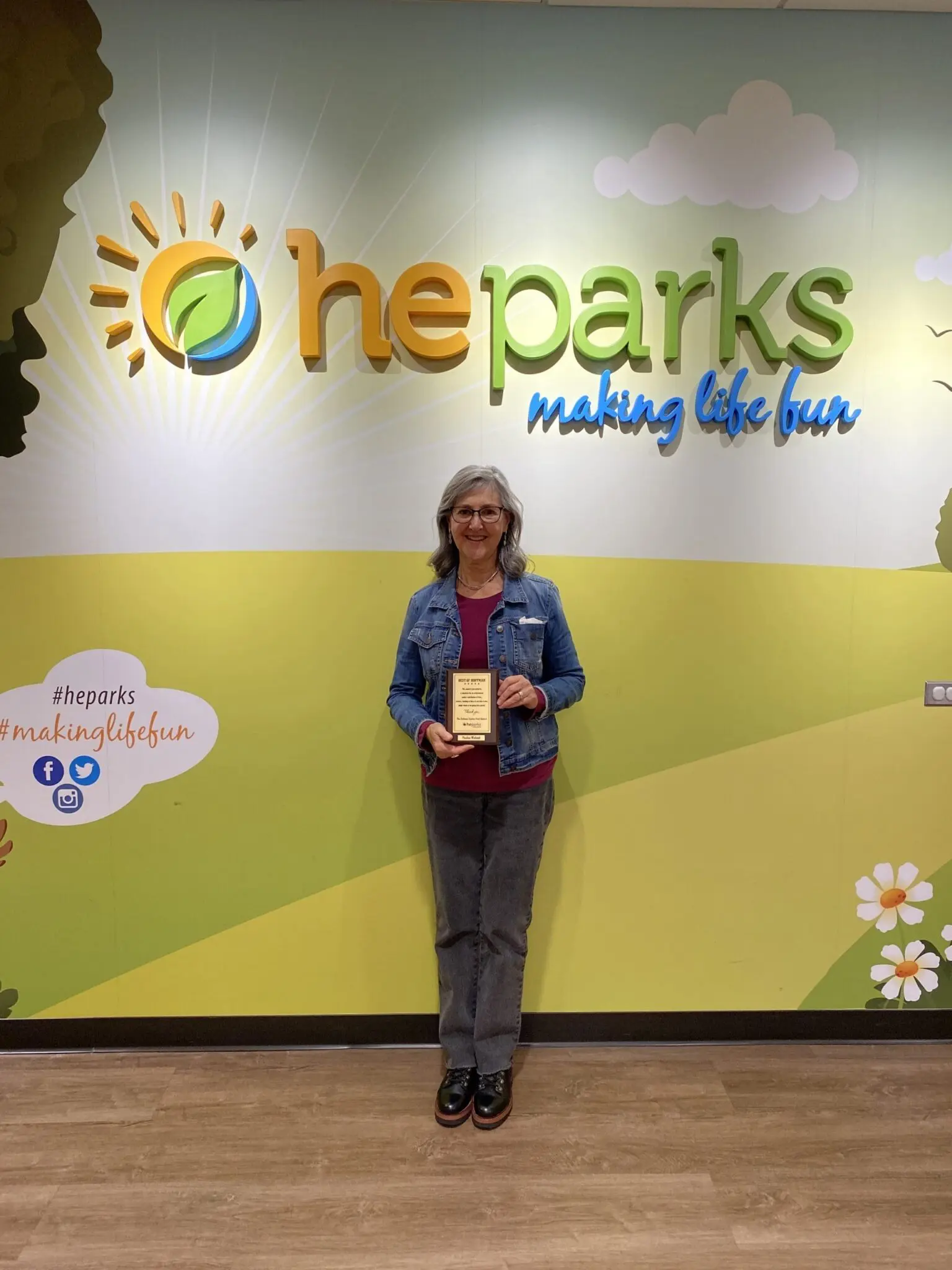 a person standing in front of a wall with a plaque