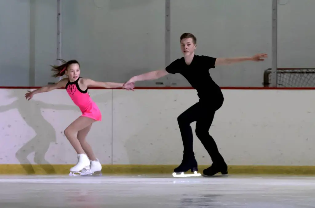 a child and child ice skating