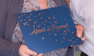 a person holding a blue sign