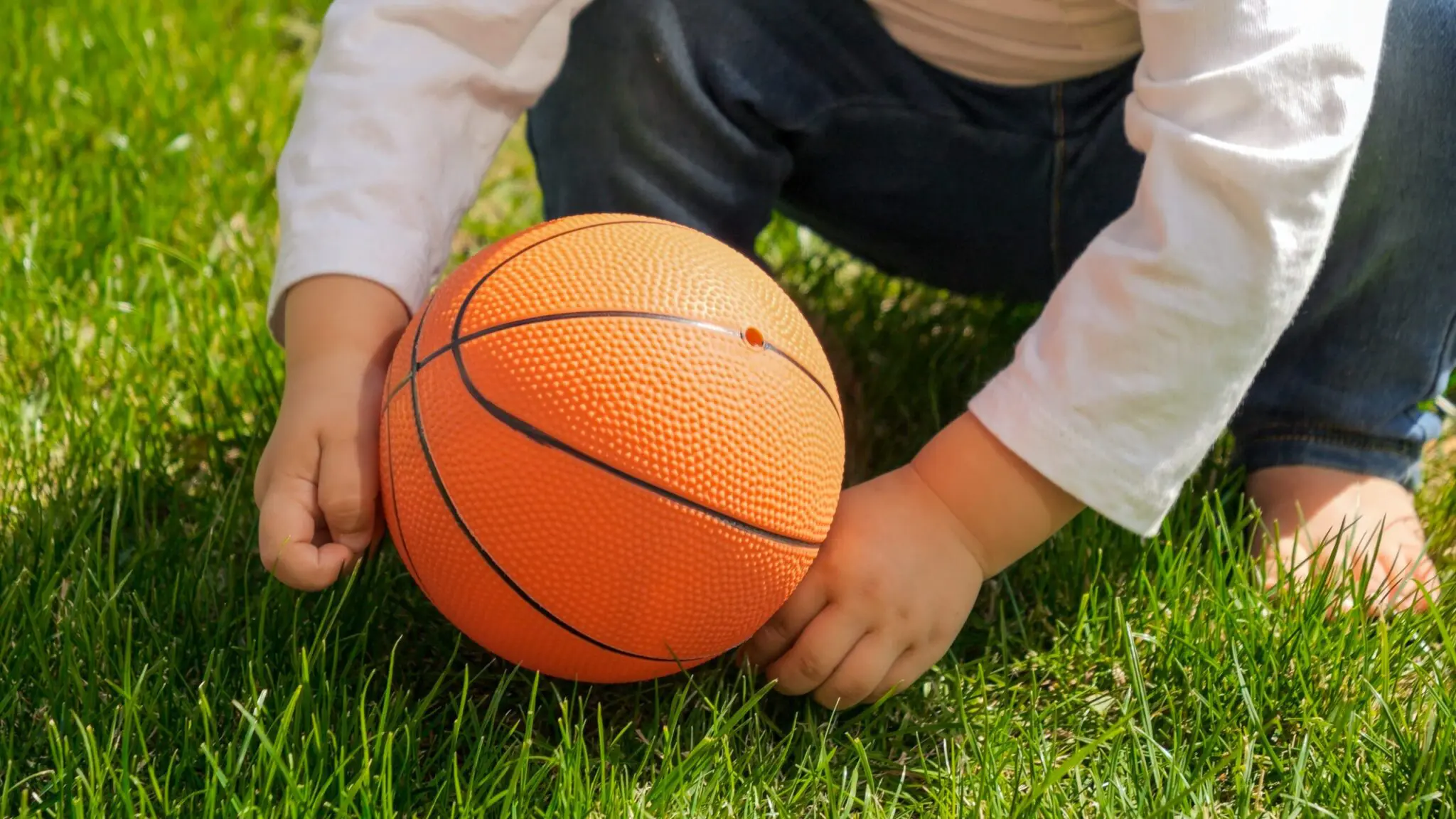 a child holding a basketball