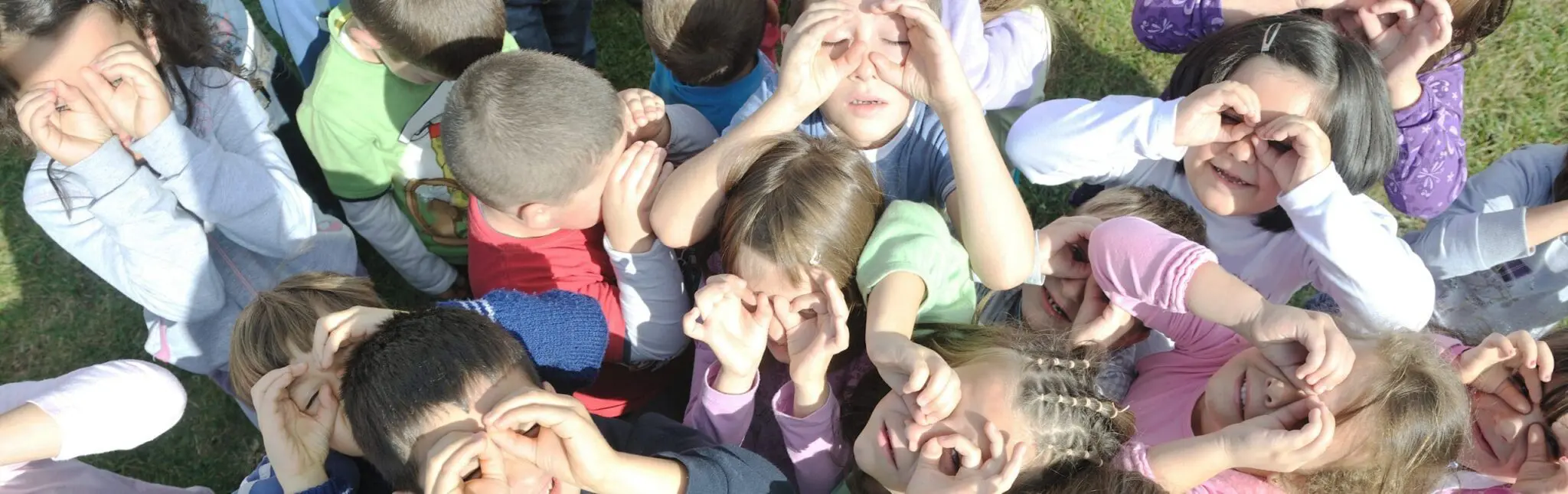 a group of children making faces with their hands