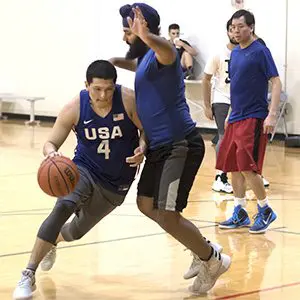 Adults playing basketball