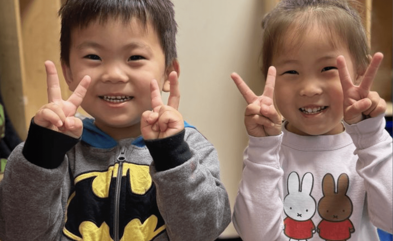 a couple of children holding up their fingers