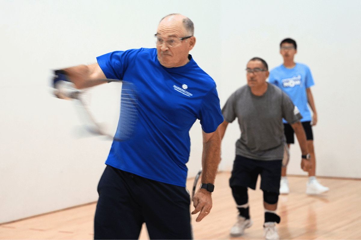 3 men playing raquetball