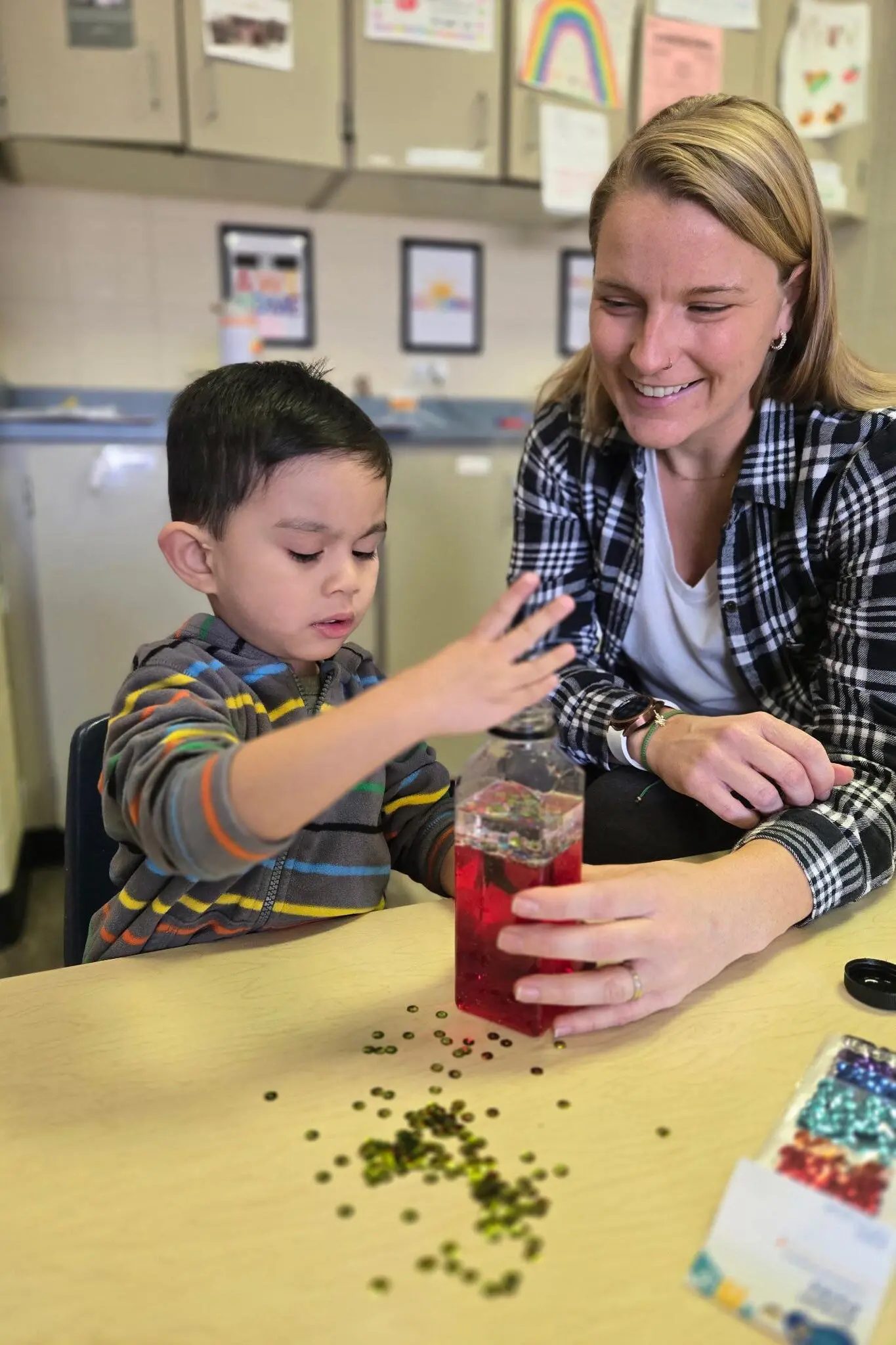 a person and a child playing with a bottle