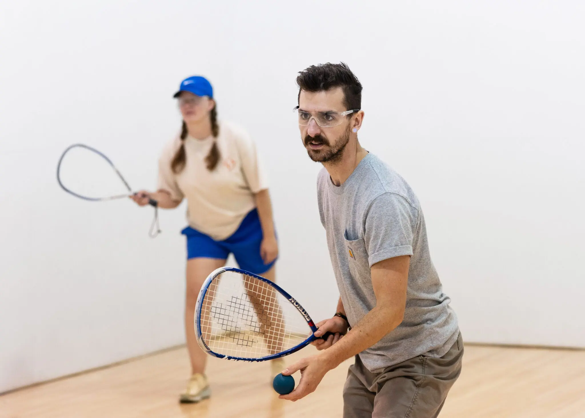 two adults playing racquetball
