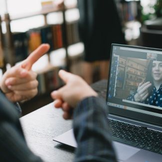 Hands signing ESL at a computer training course
